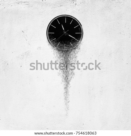 Classic clock on white concrete background disintegrate in a small parts and flowing away. Time flying concept Royalty-Free Stock Photo #754618063