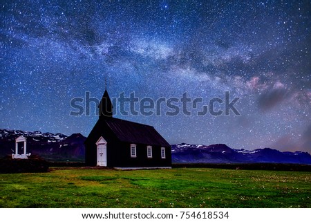 Mountain View Iceland. Fantastic starry sky and the milky way. Beautiful black wooden church in Budir.