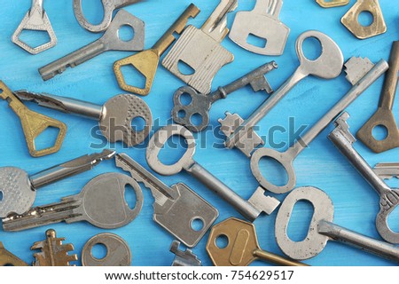 background from various keys on a blue wooden background - top view of the keys