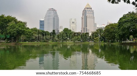 Bangkok city landscape from Lumpini park in the evening with reflection.1