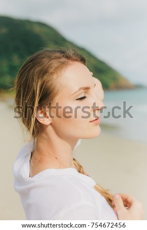 Portrait of a beautiful young blond woman on the tropical beach.