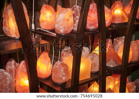Shelves full of Himalayan salt lamps of all shapes and sizes ready to be sold. Royalty-Free Stock Photo #754695028