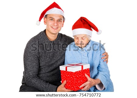 Picture of an old lady receiving Christmas gifts from her grandson