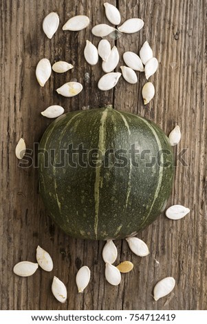 Cut pumpkin on a wooden board. Harvest. Food background.