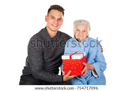 Picture of an old lady receiving birthday gifts from her grandson
