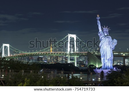Statue of Liberty in front of Rainbow bridge in Odaiba, Tokyo, Japan