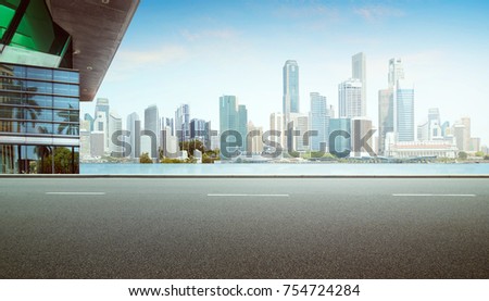 Empty highway asphalt roadside with modern architecture and city sea skyline background .