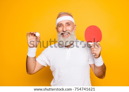 Competetive emotional cool active goofy comic grey haired grandpa with humor grimace and beaming grin, with table tennis equipment. Healthcare, weight loss, bodycare lifestyle