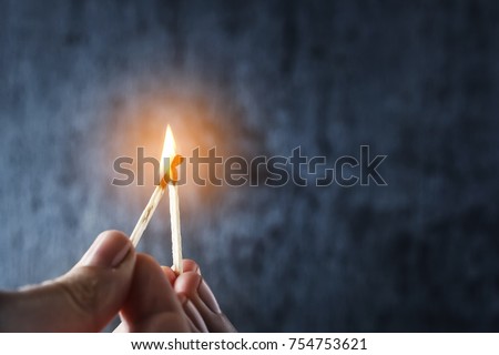 One match sets the other on fire. Fire from matches on a dark blue background. The concept of support, leadership. Photo with copy space.
 Royalty-Free Stock Photo #754753621