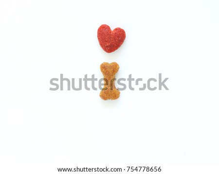Close up of dog food in shape of bone and heart shape on white background, Can use for pet food  background, pet product design. Royalty-Free Stock Photo #754778656