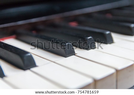 row of piano keys shot in a shallow depth of field 