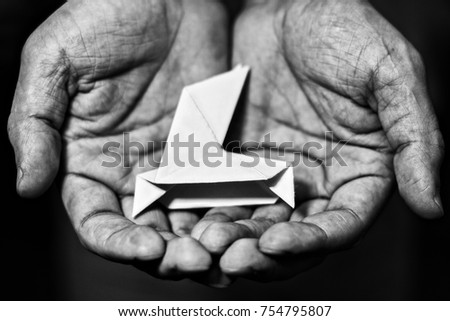 in men's palms lies paper dovein, black and white