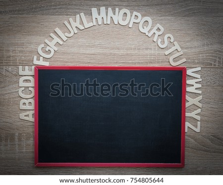 Top view wooden alphabet study english letters,ABC on the blackbroad as a background composition with copy space