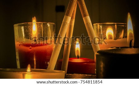 Different configurations with cigarettes and burning candles.