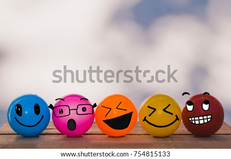 Happy Cheerful Smiley face yellow, orange, red, blue and pink balls with bokeh wall background and copy space