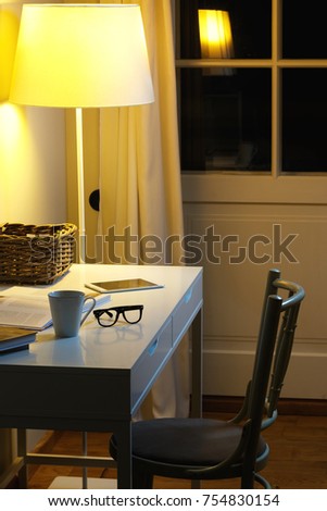 Different objects on the desk - Cup of hot drink, spectacles, books and tablet PC