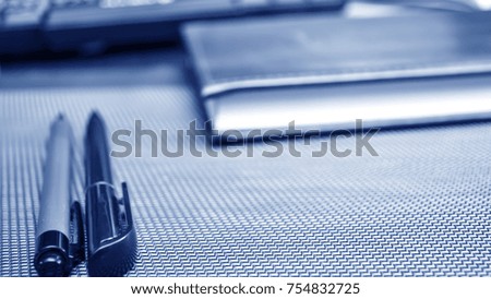 Stationery items lying on the desktop. Place to work at home.