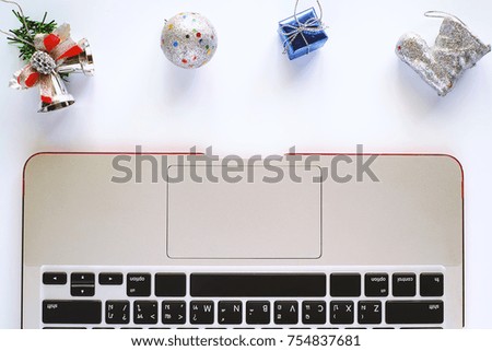 Computer Laptop for working with Christmas and New Year ornaments and decoration on white background