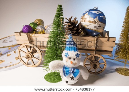New Year, Christmas, New Year's decorations, a cart with new Christmas trees and balls, a little snowman