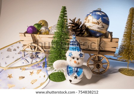 New Year, Christmas, New Year's decorations, a cart with new Christmas trees and balls, a little snowman