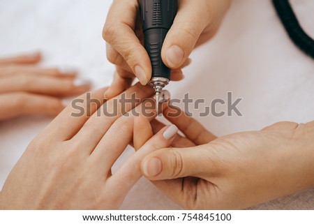 Manicurist with a milling cutter for manicure