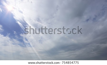 Dramatic sun rays and clouds as background