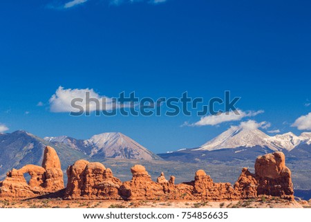 Beautiful scenery in the Arches National Park, Utah, with white capped mountains profiled in the background