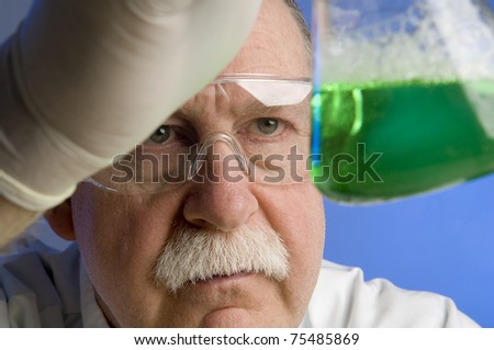 Chemist looking closely at his latest discovery
