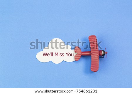 writing We'll Miss You red toy airplane with cloud on blue background Royalty-Free Stock Photo #754861231