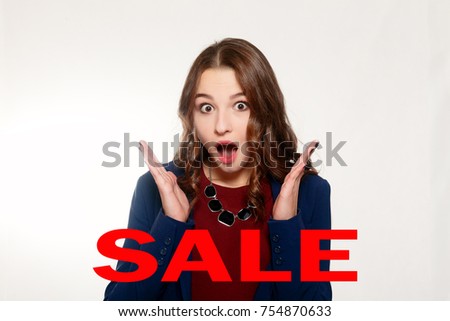 sale, black Friday, emotions, people, beauty concept- Woman surprise showing product .Beautiful girl pointing to the side . Presenting your product. Expressive facial expressions