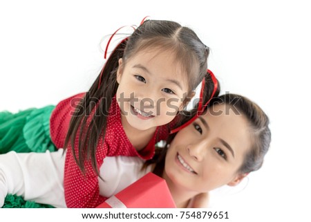 Portrait of Attractive Woman and Girl looking to Camera at white background. Happy Family Concept.