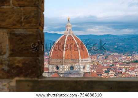 View of Florence through the window.
View of La Cattedrale di Santa Maria del Fiore through a glass window.