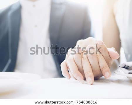 A couple holding each hand with the ring put on finger.This picture is a concept to mean a love.
