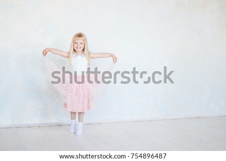 small happy girl dancer isolated.Cute little dancing, jumping,running child.  Children dance. Kids performing. Young gifted dancer in a class.Baby girl is studying ballet, modern dance.copy space