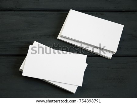 Two stacks of cards on a white background black vintage table. Simple and concise mock up for visualization of corporate style Royalty-Free Stock Photo #754898791
