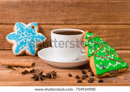 White Cup with coffee and christmas gingerbread . Christmas Food decor on wooden background
