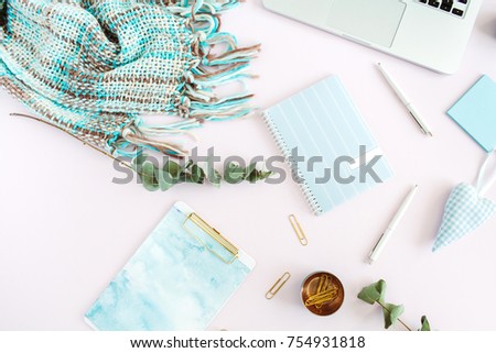 Flat lay home office desk. Women workspace with clipboard, laptop, diary, stationery on pale pink background. Top view feminine concept.