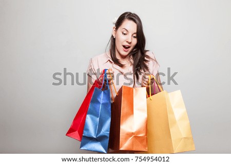 Attractive young woman is very surprised how much she bought on black friday for christmas