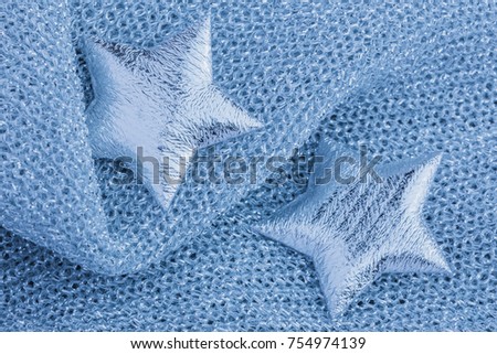 Picture of a shiny silver star on a gray texture cloth