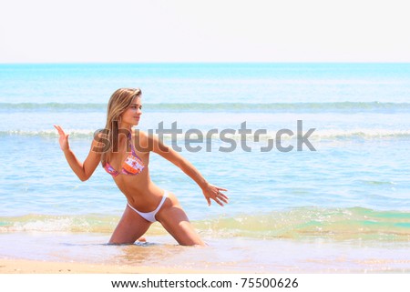 beautiful young latino woman wearing a bikini portrait on beach