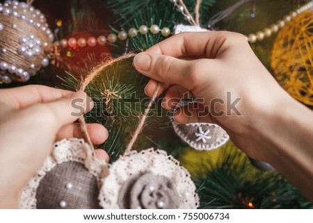 Hipster hands with Christmas toy and tree background. xmas decorations with toys, sparkling, glowing. Happy New Year and Xmas theme