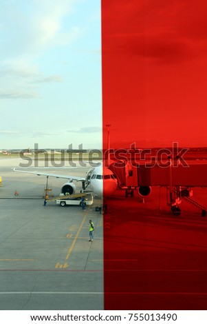 Airplane ready for boarding in airport. Travel and transportation concepts. A photo through a colored glass of the airport