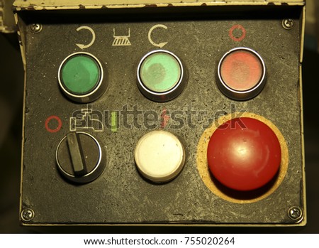 old black control panel with round colored metal buttons