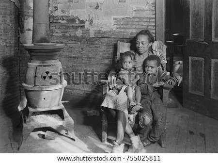 Wife and children of an unemployed African American coal miner in Scott's Run, West Virginia. Photo by Lewis Hine, March 1937. Royalty-Free Stock Photo #755025811
