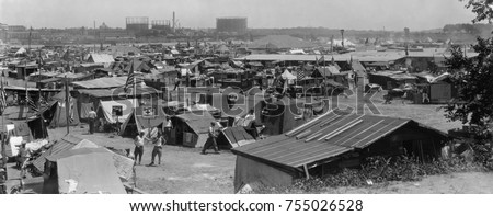Bonus Army shacks at Anacostia Flats, Washington, D.C. July 1932. These are encampments of the 45th and 47th 'Bonus Expeditionary Forces' which include tents, shacks, and cars. Royalty-Free Stock Photo #755026528