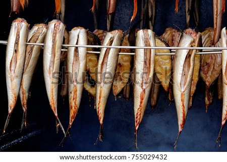 Smoked fish hanging in a smokehouse