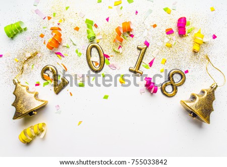 2018 new year background with confetti, sparkles, glitter, serpentine, gold Christmas trees toys, on white. Top view, close-up. Festive greeting card with copy spase