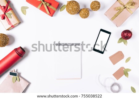 New Year decorations, notebook and smart phone on a white table top view