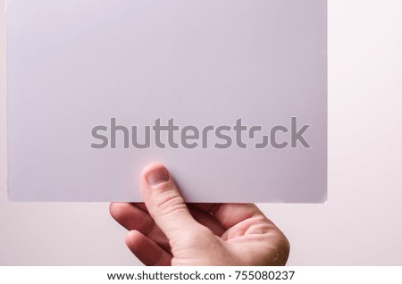 sheet of paper in hand