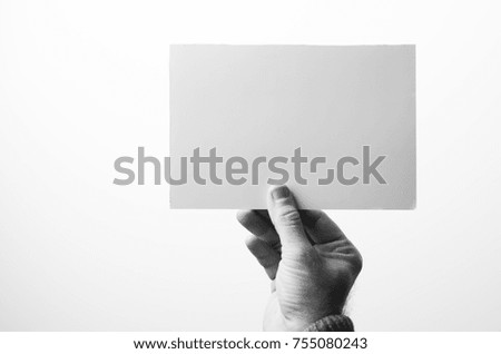 sheet of paper in hand